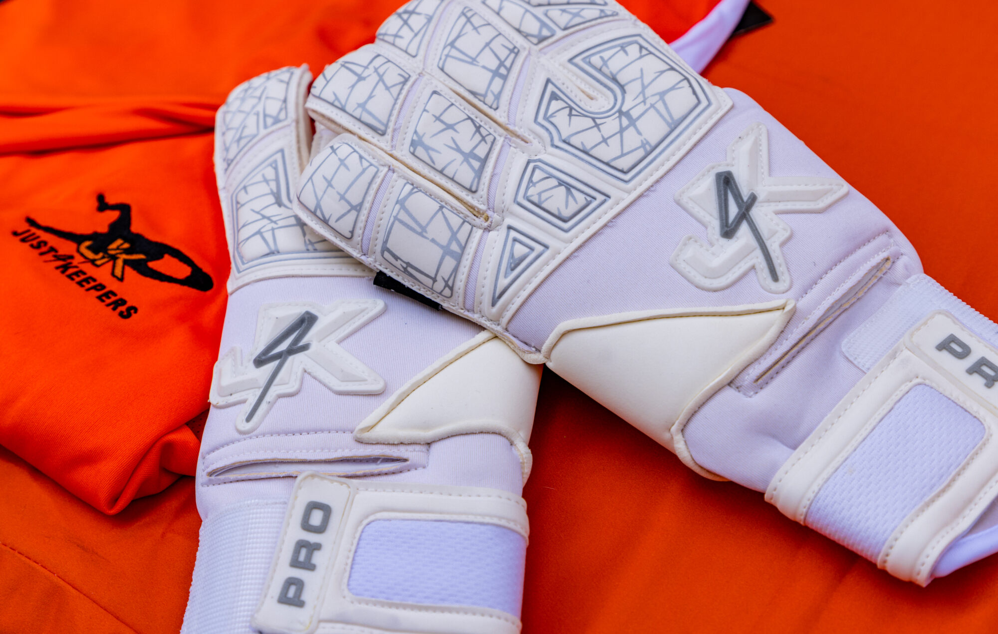 White glove against an orange background